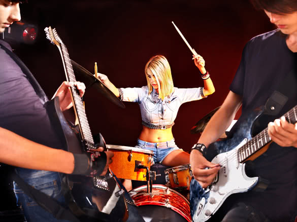 Young woman playing drums in night club