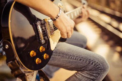 guitar player playing song outdoor