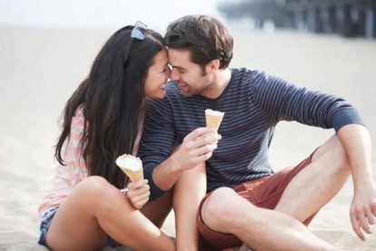 happy couple with ice cream near santa monica pier