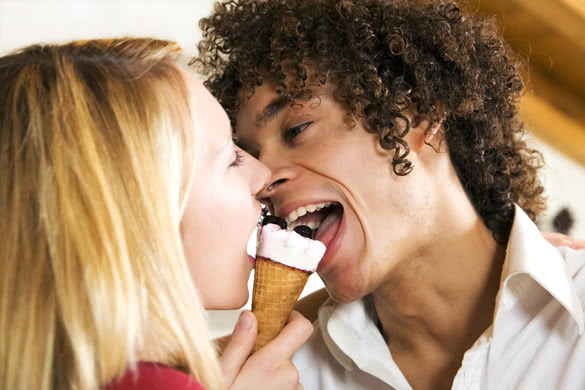 interracial couple sharing an ice cream
