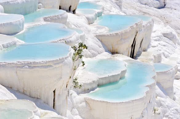 Blue cyan water travertine pools at ancient Hierapolis Pamukkale