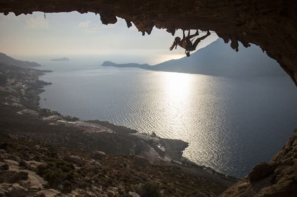 Family rock climber against picturesque view of Telendos Island at sunse