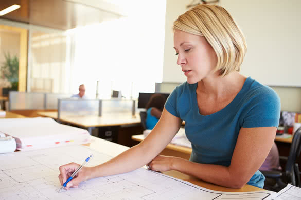 Female Architect Studying Plans In Office  5