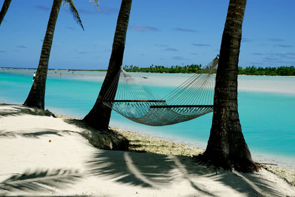 Palms and hammock at waters edge, Aitutaki Cook Islands