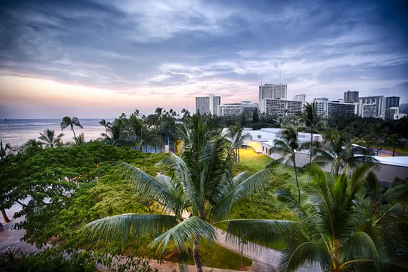 The park near Waikiki Beach with the city skyline of Oahu
