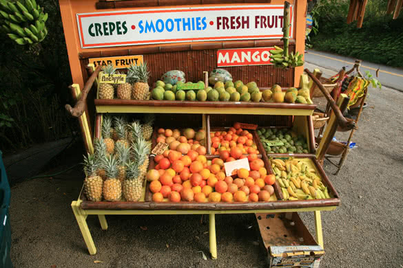 pineapples and other fruits for sale at a roadside stand on maui hawaii