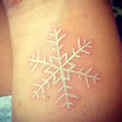 Small Snowflake White Ink Tattoo