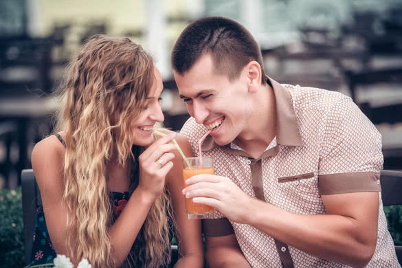 young couple with drinks in cafe outdoor