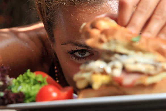 Woman eating a yummy cheeseburger