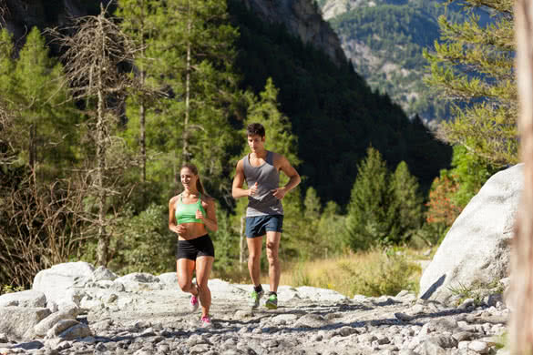 young sporty couple doing running in the mountains