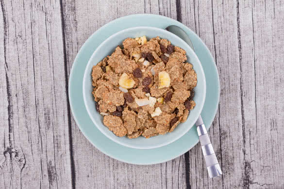 A Bowl of Bran Flakes on a Rustic Table