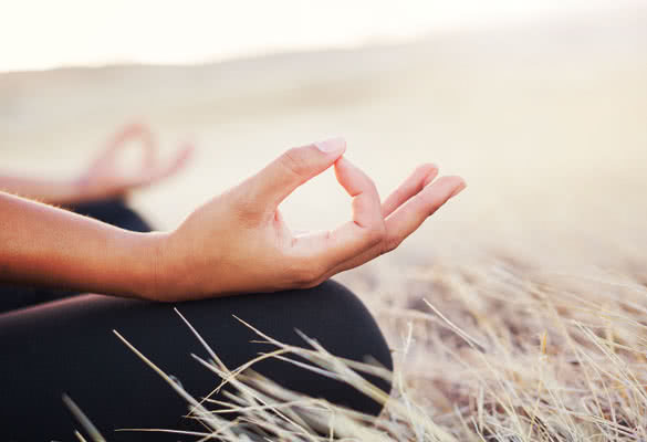 Woman meditating practicing yoga outdoors