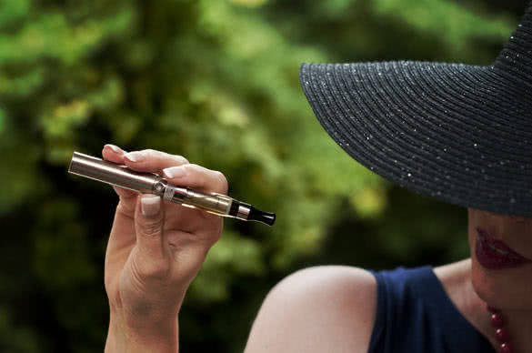 fashion woman with e-cigarette in outdoor