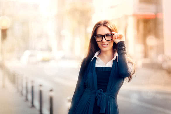 Beautiful young woman with glasses out in the city