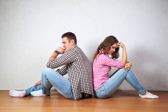 Couple sitting with their backs turned after having an argument