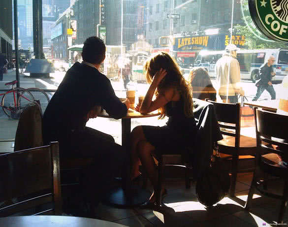 couple sitting in cafe and looking thru the window