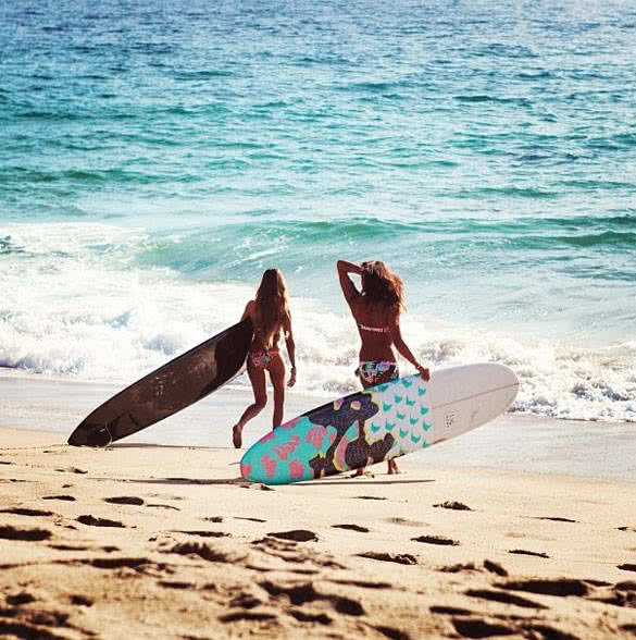 two young woman surfing