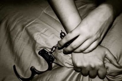 woman handcuffing a man