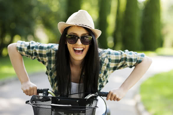 Happy-young-woman-with-bicycle