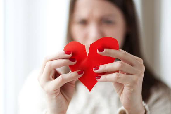 Image-of-woman-tearing-paper-heart-apart,-shallow-depth-of-field