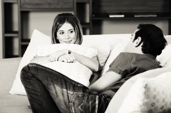 couple-having-conversation-sitting-in-the-living-room