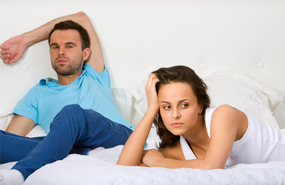 couple in bed not talking to each other