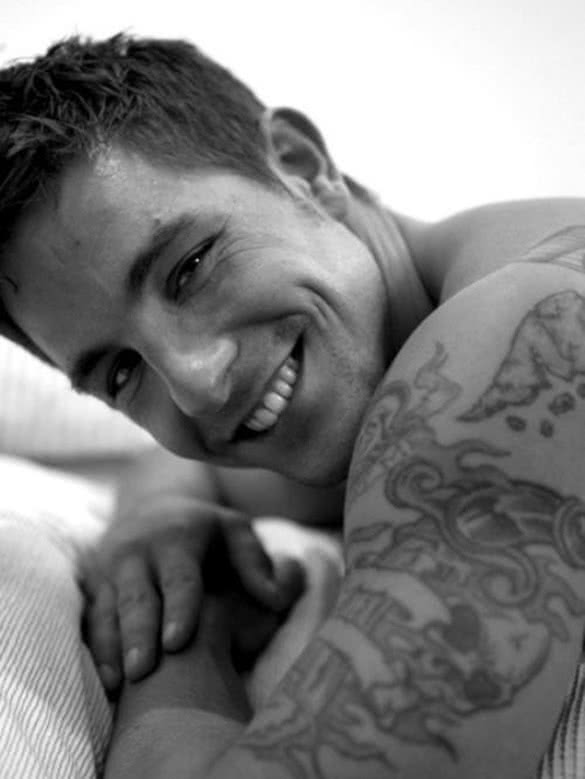 cute-guy-smiling-with-tattoo-on-his-arm