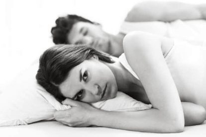sad-woman-in-bed-with-man