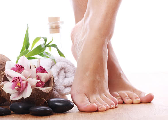 woman-feet-rocks-and-flowers