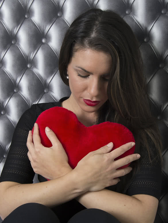 woman-holding-red-heart-pillow