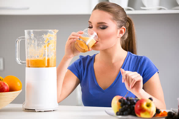 woman-in-blue-shirt-drinking-smoothie