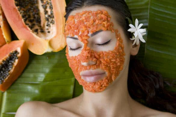 Beautiful caucasian woman having fresh papaya natural facial mask apply