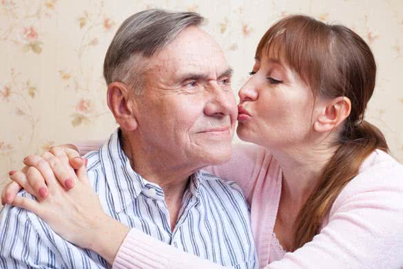 Family adult daughter kissing senior father