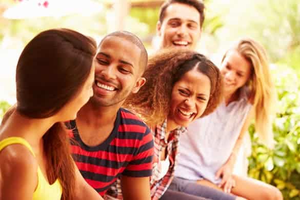 Group Of Friends Relaxing Outdoors On Holiday Together