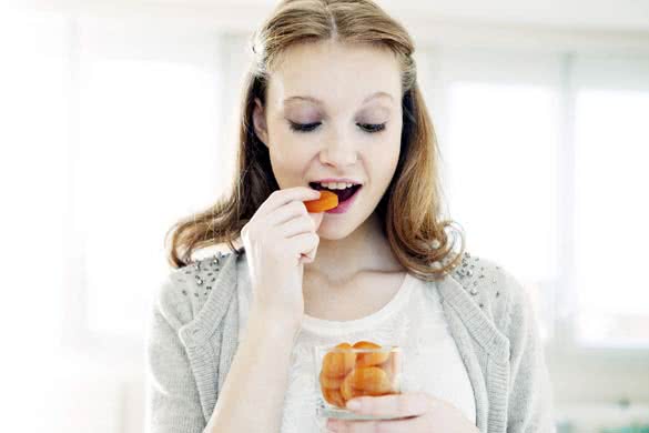 Woman Eating Dried Fruit