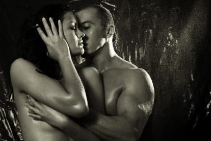 Loving affectionate nude heterosexual couple in shower engaging in sexual games