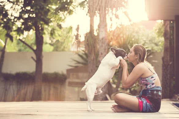 Women hugging a dog and kiss