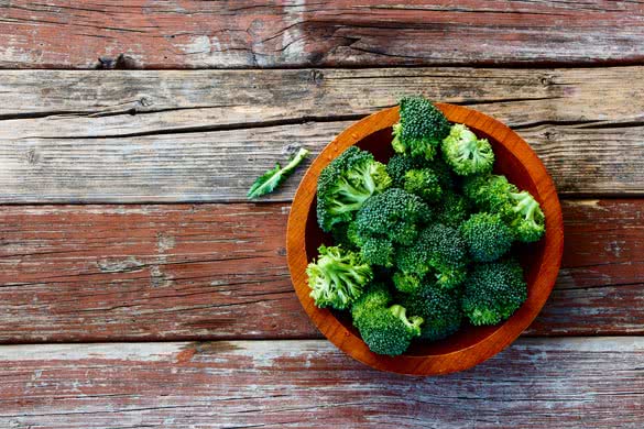 Fresh green broccoli in wood bowl