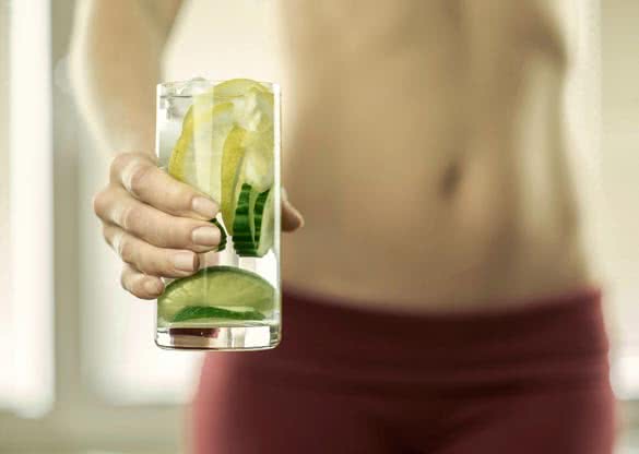Healthy coctail in the hands of fitness female