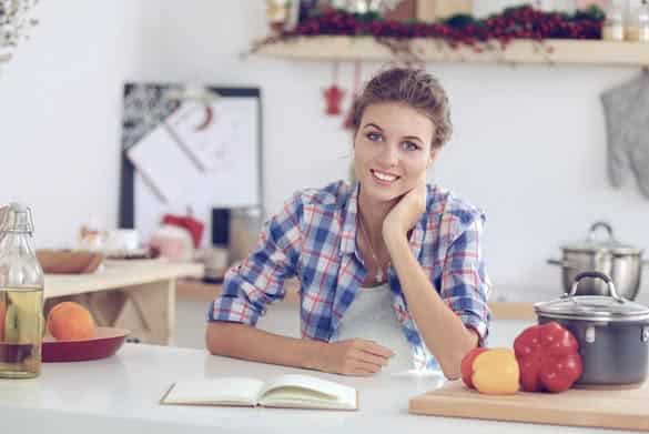 Smiling young woman in the kitchen