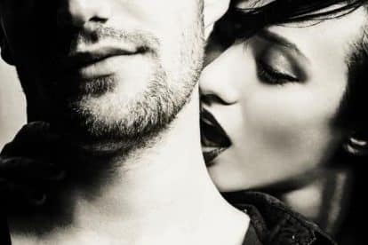 Woman kissing a man on the neck