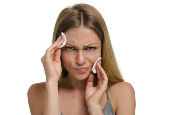 Young beautiful woman with cotton pad