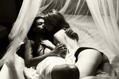 Young passionate couple mixed race making love in bed