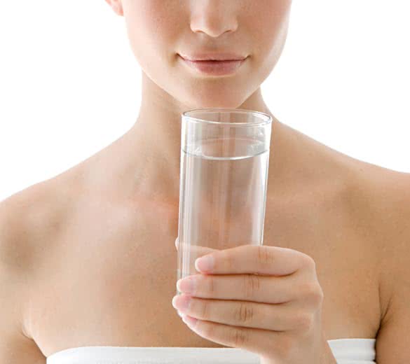 young healthy woman and a glass of clean water