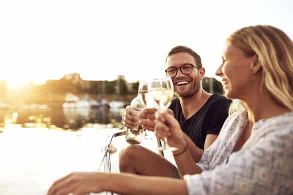 Happy Couple Toasting Glasses on a Summer Evening