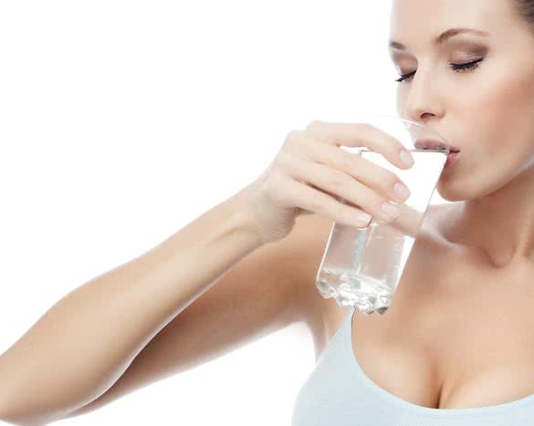 portrait of attractive caucasian woman isolated on white studio shot drinking water