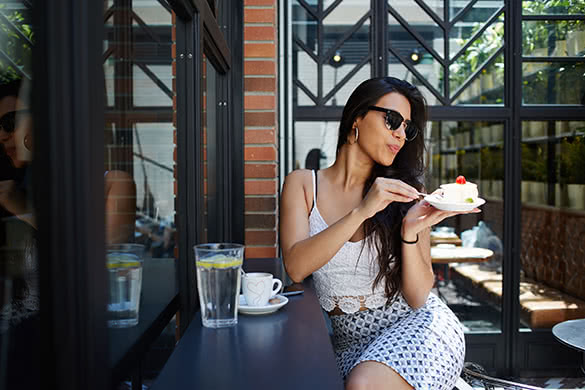 confident girl eating cake