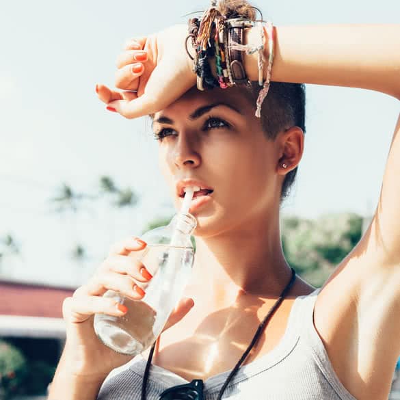 Portrait of young woman drinking water