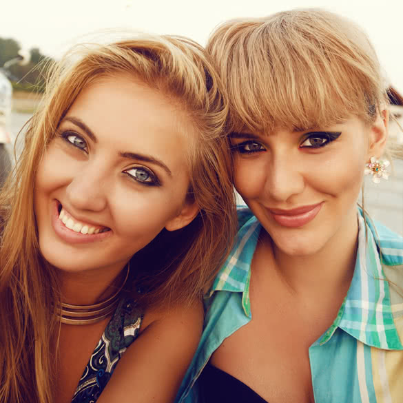 Summer sunny portrait of two young pretty blondes