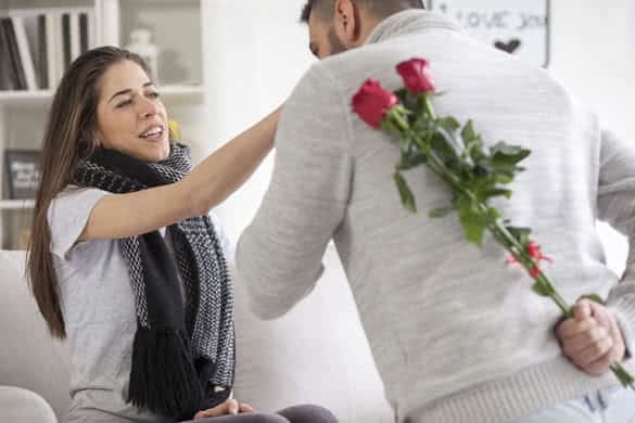 Young man gives a girl flowers